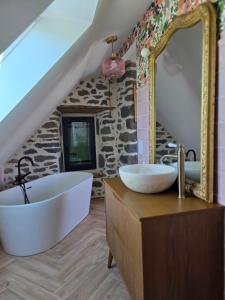 a bathroom with two sinks and a large mirror at Gîte Le Cheix d'Arches in Arches +51 photos