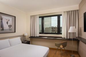a hotel room with a bed and a window at UNA Hotels Bologna Fiera in Bologna
