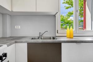 a white kitchen with a sink and a window at Apartment Gerwies in Bronzolo +28 photos