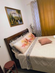 a bedroom with a bed with flowers on it at B&B La Casa di Olga in Bobbio