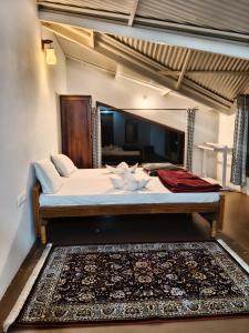 a large bed in a room with a large bed sidx sidx sidx at The Attic at Infinity Valley in Kotagiri