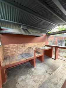 a bench and a table under a roof at Maison de Charme tout confort in Saint-André
