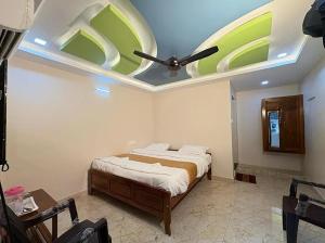 a bedroom with a bed with a ceiling fan at A One Residency in Nāgercoil