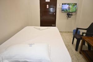 a hospital room with a bed and a tv at A One Residency in Nāgercoil