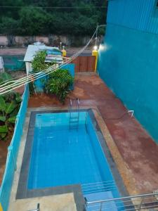 an overhead view of a blue swimming pool at D S Villa with swimming pool in Kuilapayam