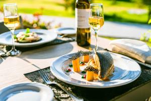 a table with plates of food and glasses of wine at Levante Athletic Resort in Afantou