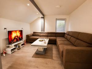 a living room with a couch and a fireplace at Bate Bole Mountain Villa in Elshani