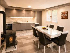 a kitchen and dining room with a table and a fireplace at Bate Bole Mountain Villa in Elshani