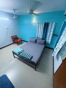 a room with a bed and a chair in it at Explore Inn T-Nagar in Chennai