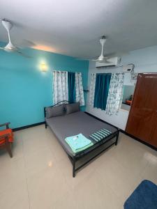 a room with a bed and a blue wall at Explore Inn T-Nagar in Chennai