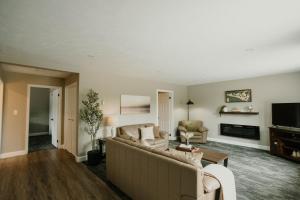 a living room with a couch and a tv at Manitoulin Inn in Mindemoya +104 photos