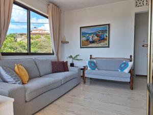 a living room with a couch and a window at LASSI Apartment 1 in Argostoli +14 photos