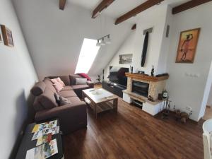 a living room with a couch and a fireplace at U Cáfi Valtice in Břeclav
