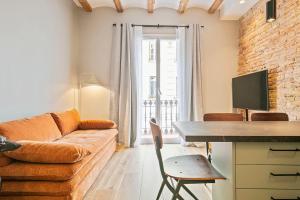 a living room with a couch and a table at The Orbit Apartments in Barcelona
