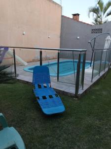 a blue slide in front of a swimming pool at Quarto em Foz, ótima localização em casa familiar in Foz do Iguaçu