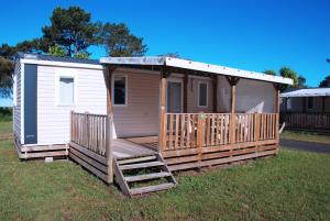 a tiny house with a porch and a ladder at VVF Labenne - Océan in Labenne