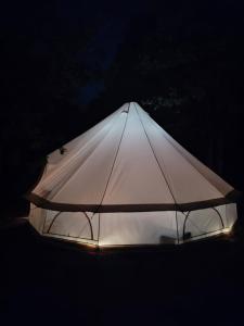 a white tent with lights on it at night at La mesange in Vaylats