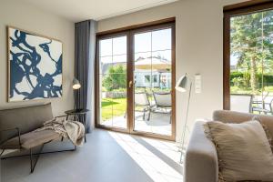 a living room with a couch and a sliding glass door at Ferienhaus Reet & Meer N 2 in Bansin