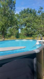 a swimming pool with a water faucet in it at La mesange in Vaylats