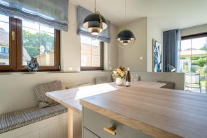 a kitchen with a wooden counter and two windows at Ferienhaus Reet & Meer N 2 in Bansin