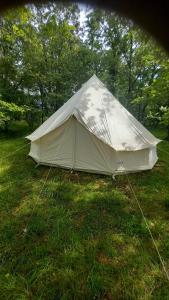 a white tent in the grass in a field at La mesange in Vaylats