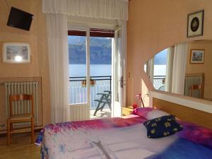 a bedroom with a bed and a large window at Casa Alessandra in Malcesine +80 photos