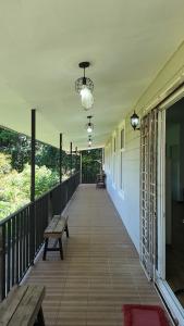 a porch with benches and tables on a house at Homestay House - Tamparuli in Tamparuli