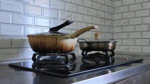 a pot and a pan on top of a stove at Homestay House - Tamparuli in Tamparuli +39 photos