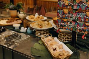 a buffet with pastries and other food on a table at Hotel Daieli in Otacílio Costa +50 photos