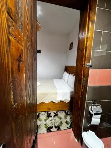 a small room with a bed and a toilet at Guest House Salaria in Gjirokastër +169 photos