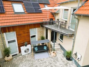 an apartment patio with solar panels on a building at FeWo D&Y -barrierefrei- in Ubstadt-Weiher