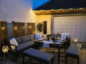a patio with a couch and a table and chairs at FeWo D&Y -barrierefrei- in Ubstadt-Weiher