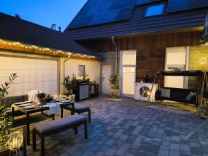 a patio with a table and chairs and a building at FeWo D&Y -barrierefrei- in Ubstadt-Weiher