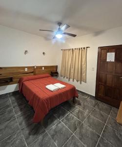 a bedroom with a bed and a ceiling fan at Piedra Alta Hotel & Restaurante in Itá Ibaté +72 photos