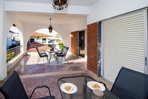 a patio with a table and chairs on a balcony at Jonathan Central Apartment in Pefkochori