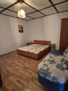 a bedroom with two beds and a wooden floor at Holiday Home Albina in Kustići +14 photos