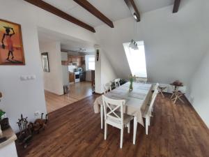 a dining room with a white table and chairs at U Cáfi Valtice in Břeclav