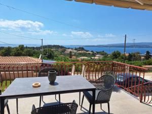 a table and chairs on a balcony with a view at LASSI Apartment 1 in Argostoli