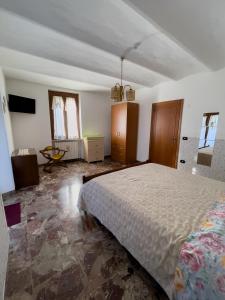 a bedroom with a large bed in a room at Flowers & Angels Home in Santa Maria degli Angeli