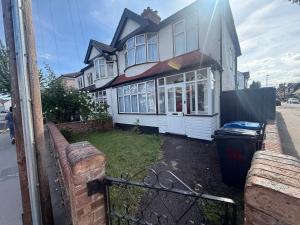 a house with a trash can in front of it at The Grenadine House in South Norwood
