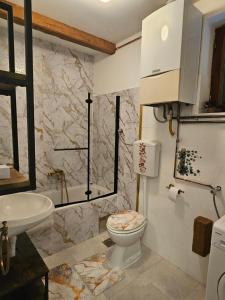 a bathroom with a toilet and a sink at Kuća za odmor Širok šor in Vukovar +36 photos