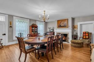 a dining room with a table and chairs and a fireplace at The Montgomery B&B in Starkville