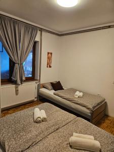 a bedroom with two beds with towels on them at Kuća za odmor Širok šor in Vukovar