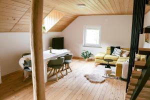 a living room with a table and a couch at TDI - Modern 2-Bedroom Apartment in nature in Kanji Dol