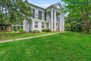 a large white house with a large yard at The Montgomery B&B in Starkville