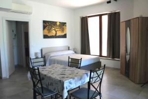 a room with two beds and a table and chairs at I Tre Ulivi 1 in Mozzate