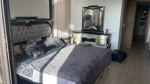 a bedroom with a large bed and a mirror at OCEAN VIEW, Prestigia Plage des Nations in Sidi Bouqnadel +27 photos