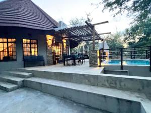 a house with a patio and a swimming pool at The ChaBo Lodge in Marloth Park +23 photos