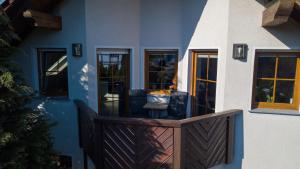 a house with a wooden porch with a deck at FeWo im Lippischen Bergland in Kalletal