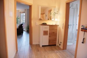 a bathroom with a sink and a shower in a room at FeWo im Lippischen Bergland in Kalletal